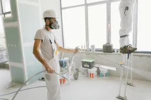 team spraying a wall with paint